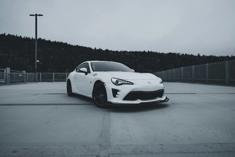 a white car sits on the empty parking lot