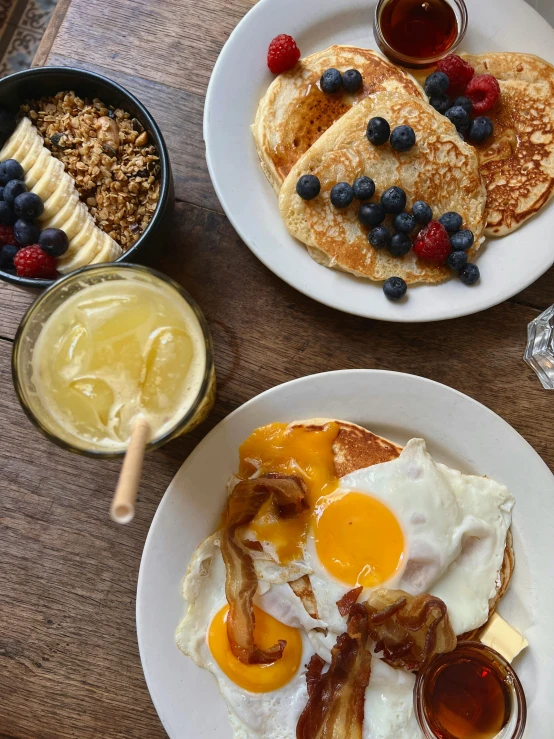 pancakes, bacon and blueberries with some syrup and fruit