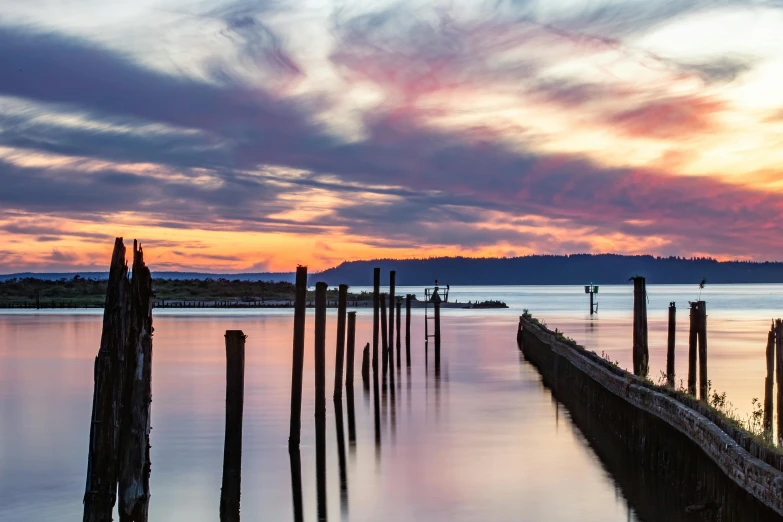 a sunset over a body of water with many piers