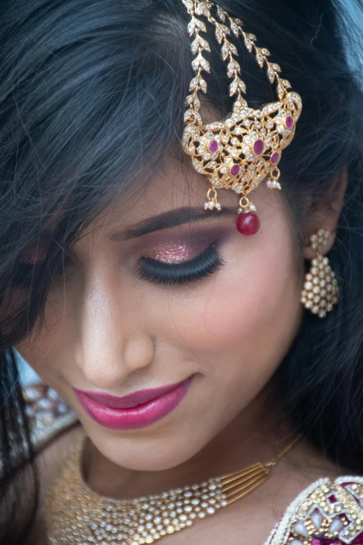 a woman is wearing a gold jewelry and jewellery set