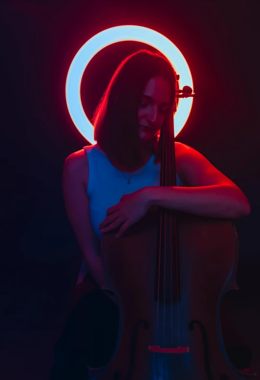 a young woman is holding onto an upright instrument