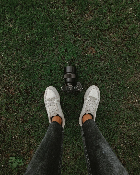 a person's feet and a camera on the ground