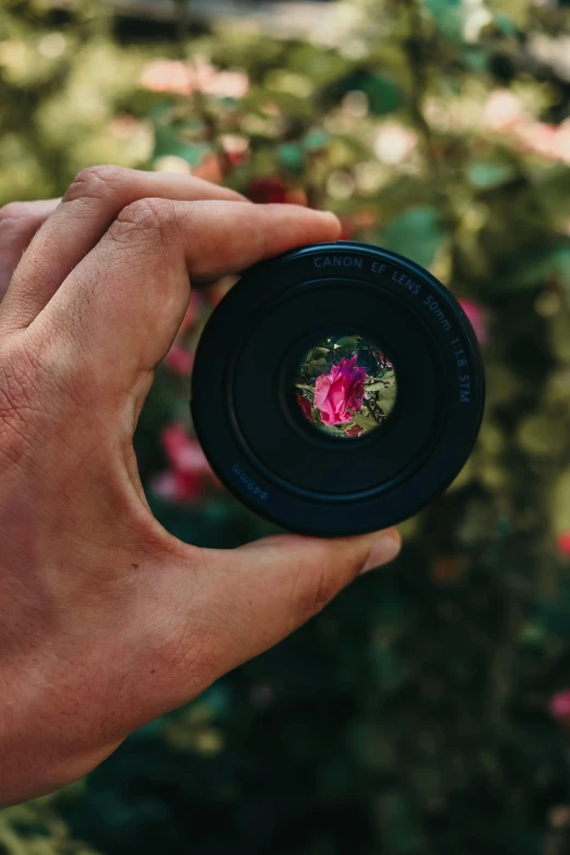 a person holding up a camera that is in their hand