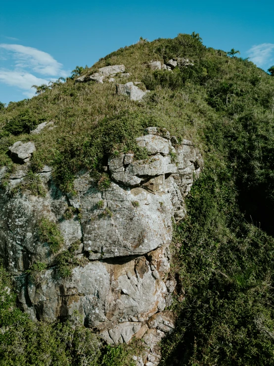 an elephant walking along side of a rocky mountain