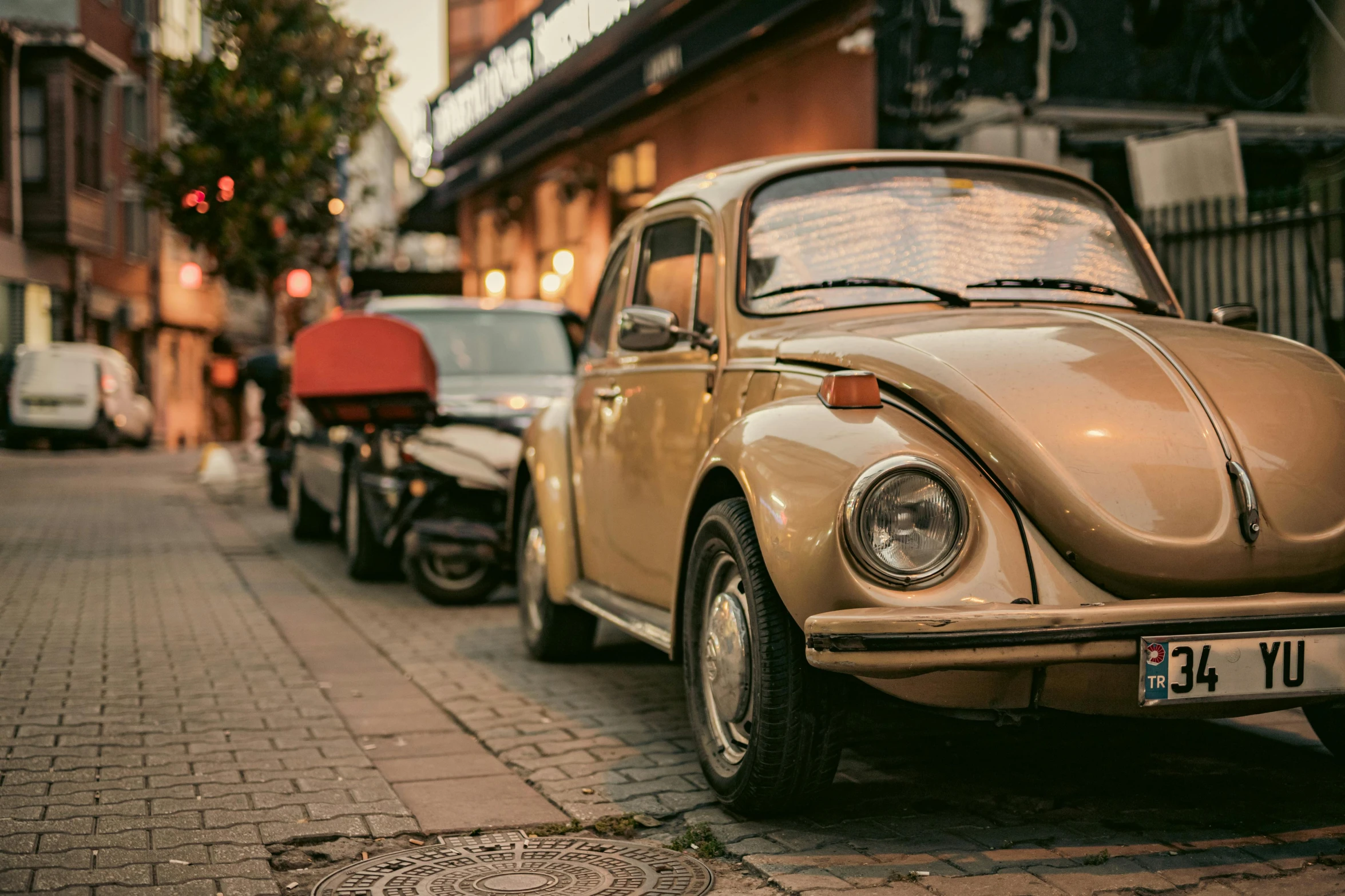 antique car on brick road next to building