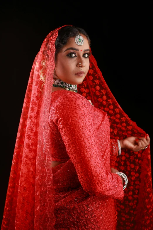 woman in red clothing standing with head piece