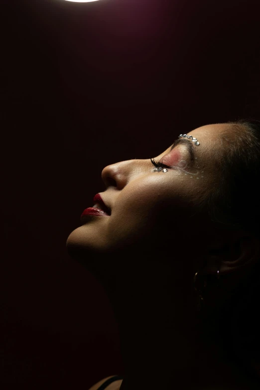 a person looking upward at the moon that is in the air