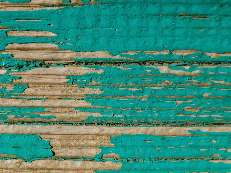 a green color peeling paint on a wall