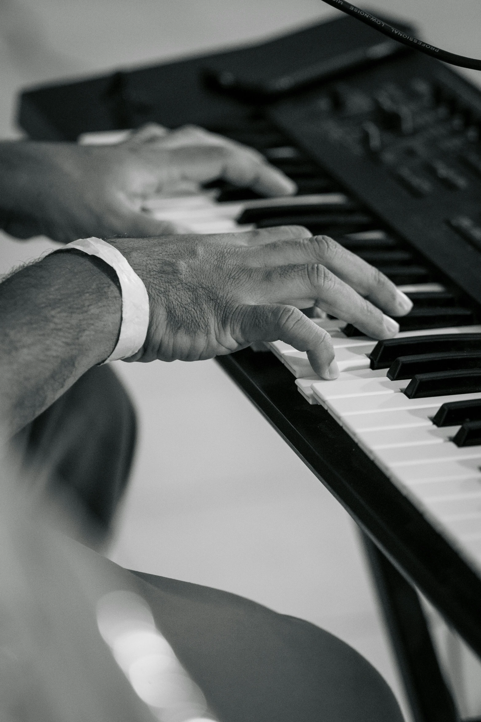 a close up of the hand of someone playing a piano