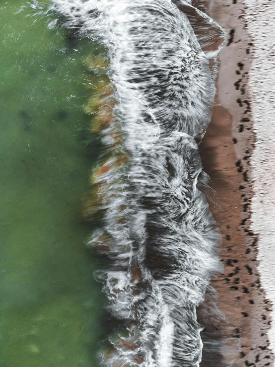 an overhead view of water and the shore