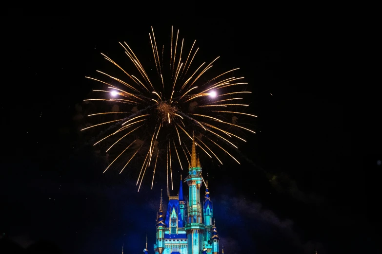 the clock tower lit up and has a fireworks display in it