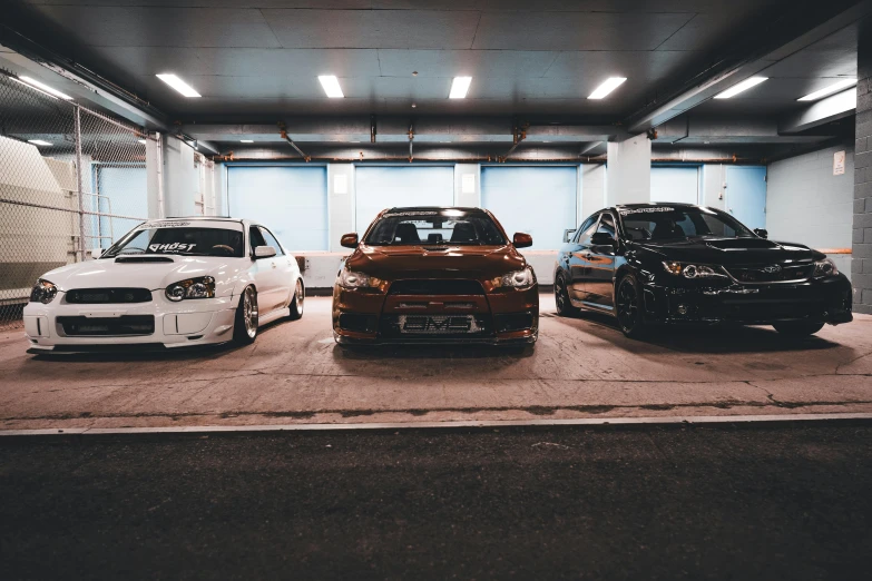 several cars parked next to each other in a garage