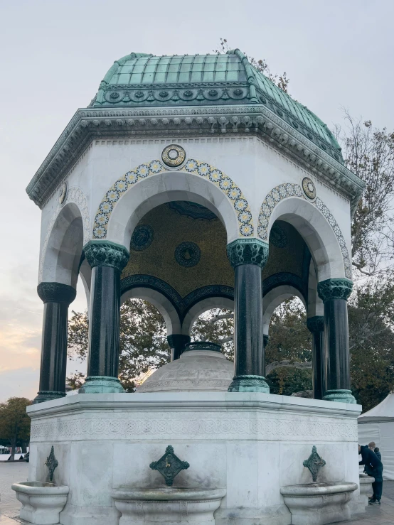 a white gazebo with two arches over it