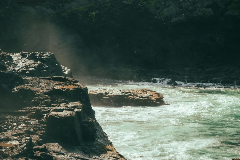 people sitting on rocks along the river side