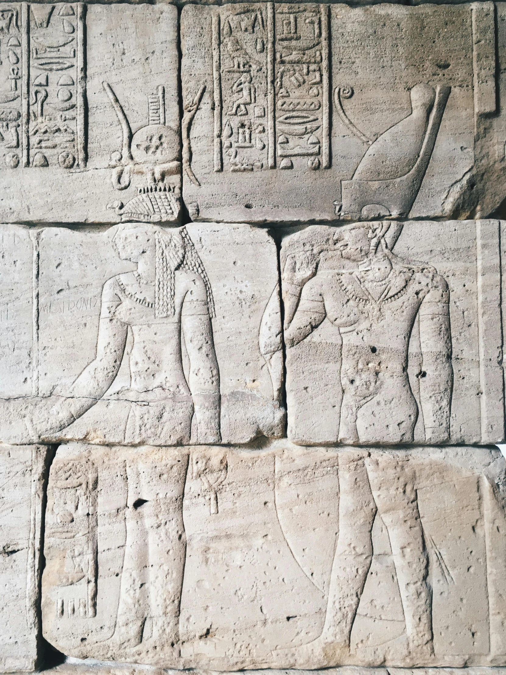 two figures on a stone wall at the egyptian ruins