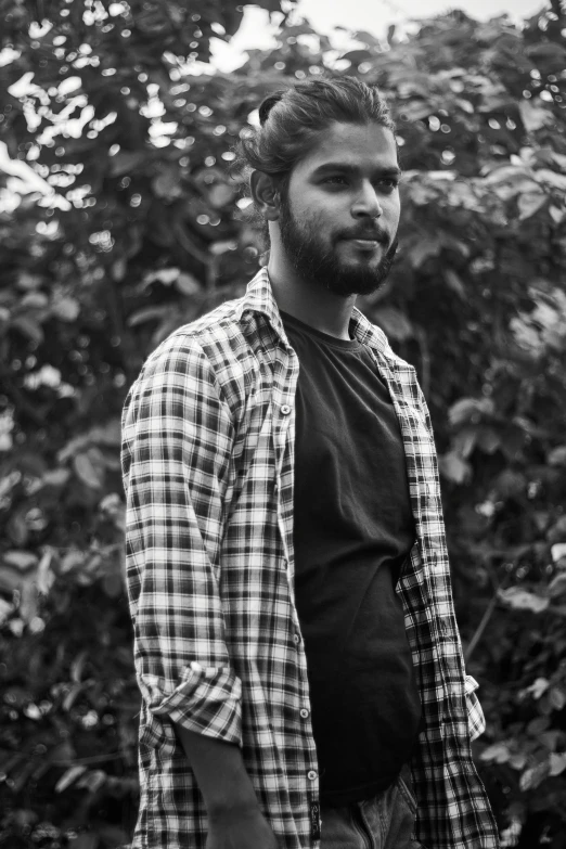 a man standing in front of a bush