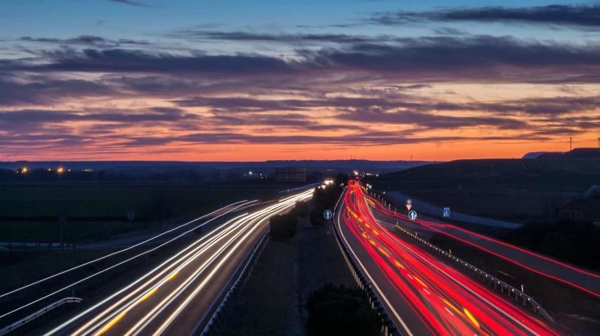 an overhead view of multiple freeway at dusk