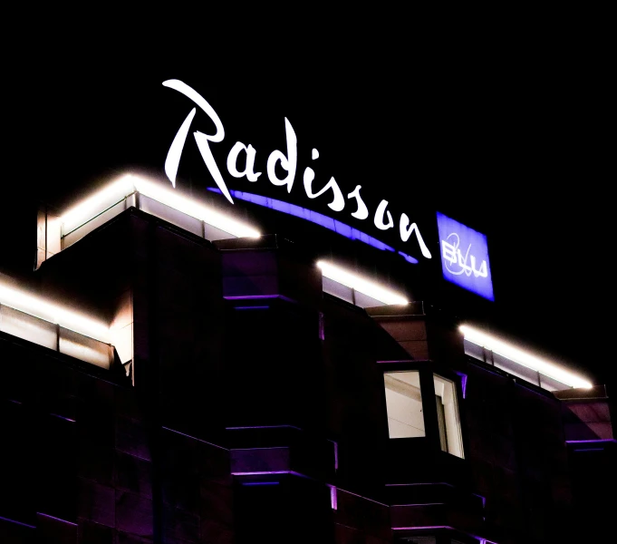 the word radison illuminated above an apartment building