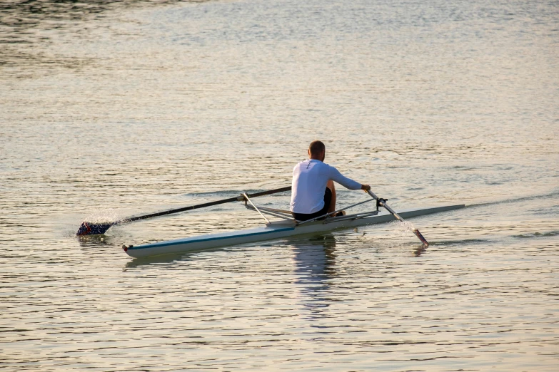 a rower is rowing in an open river