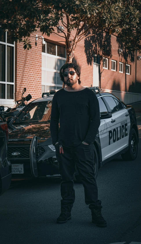 a police officer in front of some parked cars