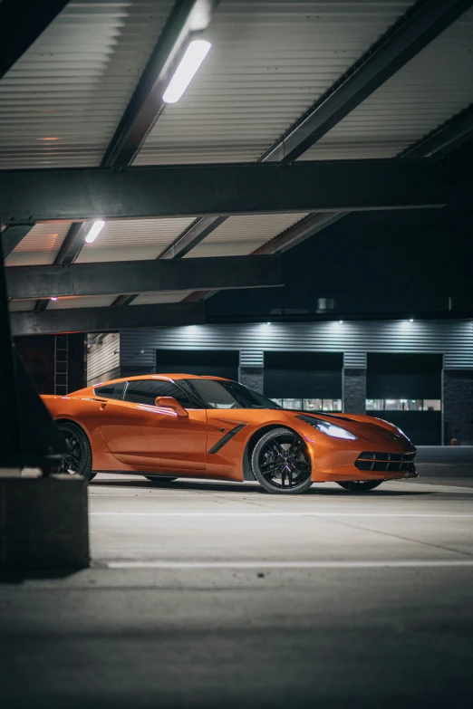 an orange sports car is parked in the street