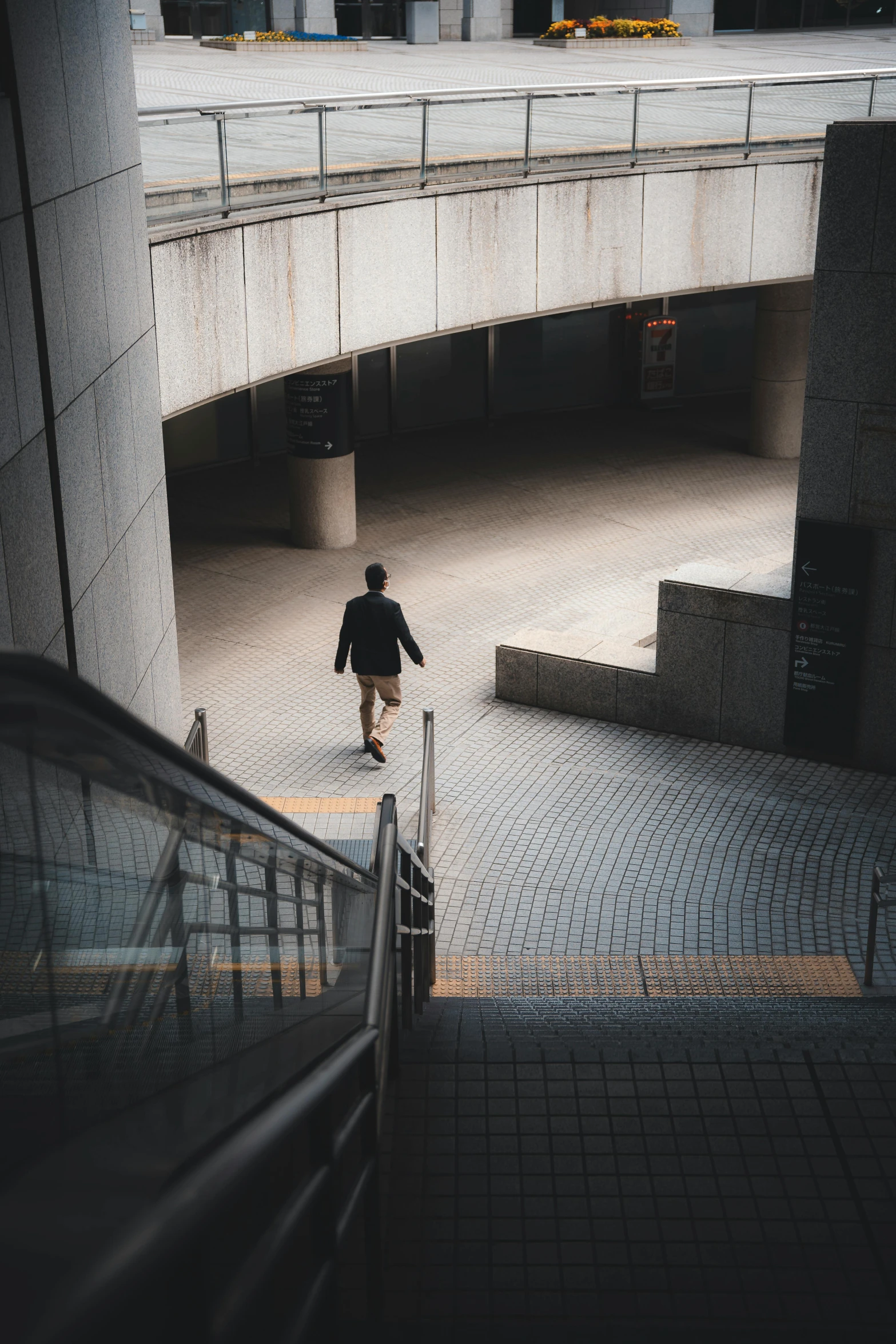 a man walking up stairs in a very large building