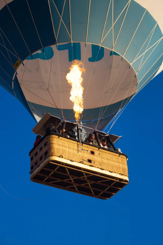 people are flying a large  air balloon