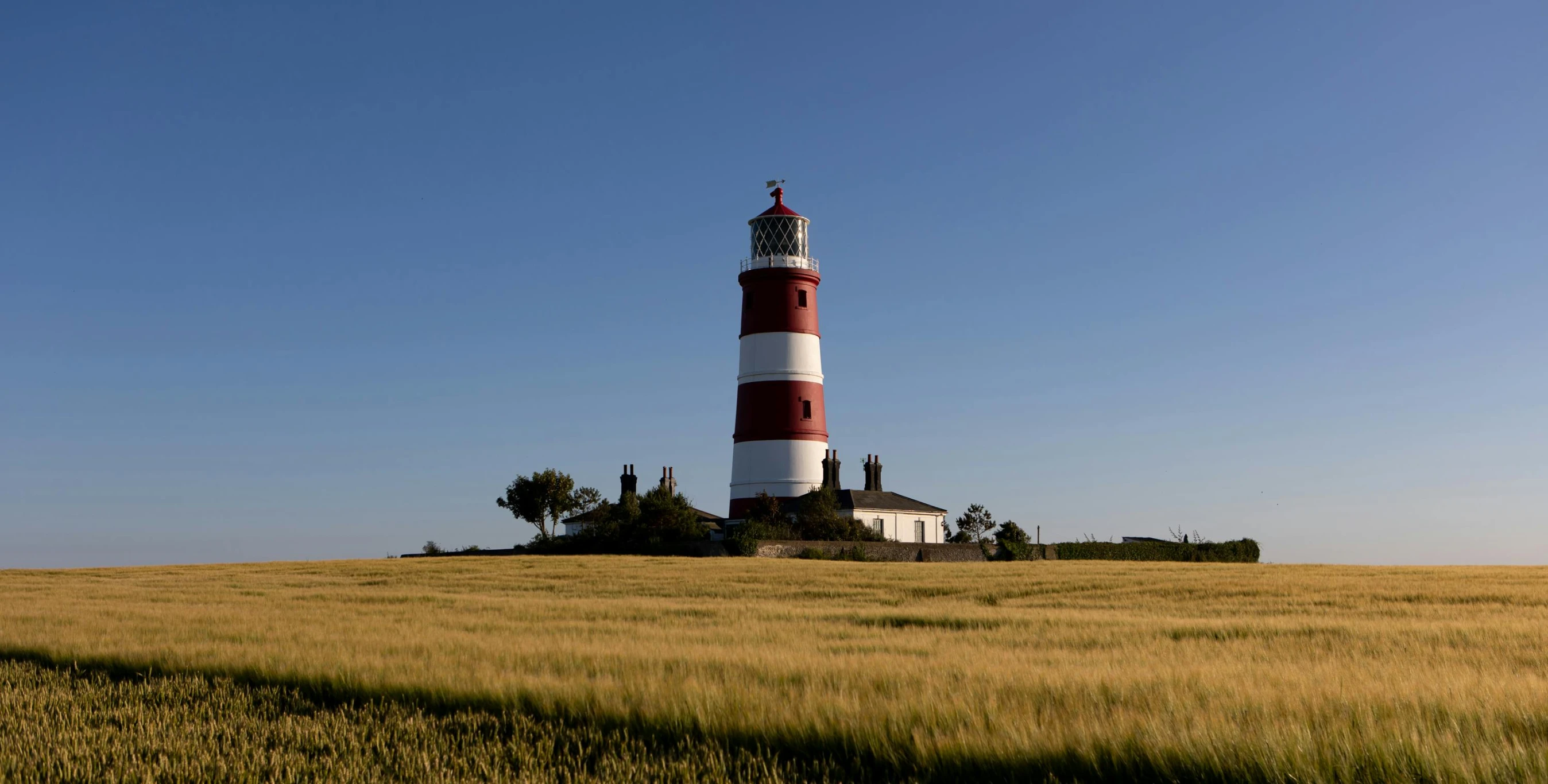 the red and white lighthouse is on top of a small island