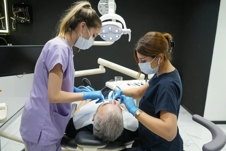 two women preparing a patient for the procedure