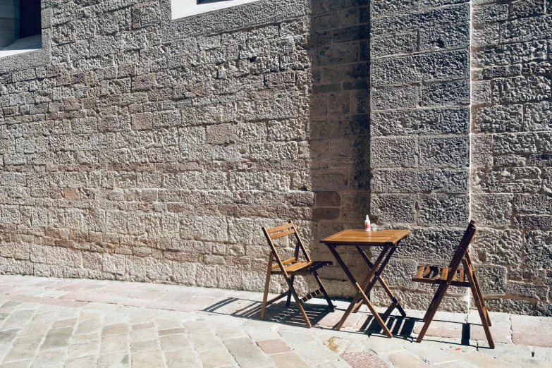 two folding chairs standing next to an outdoor table