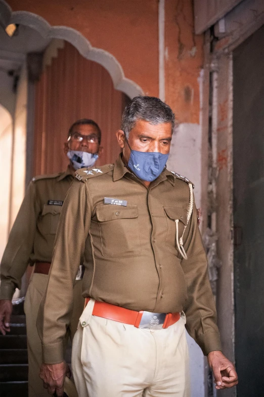 two men wearing masks while standing next to each other