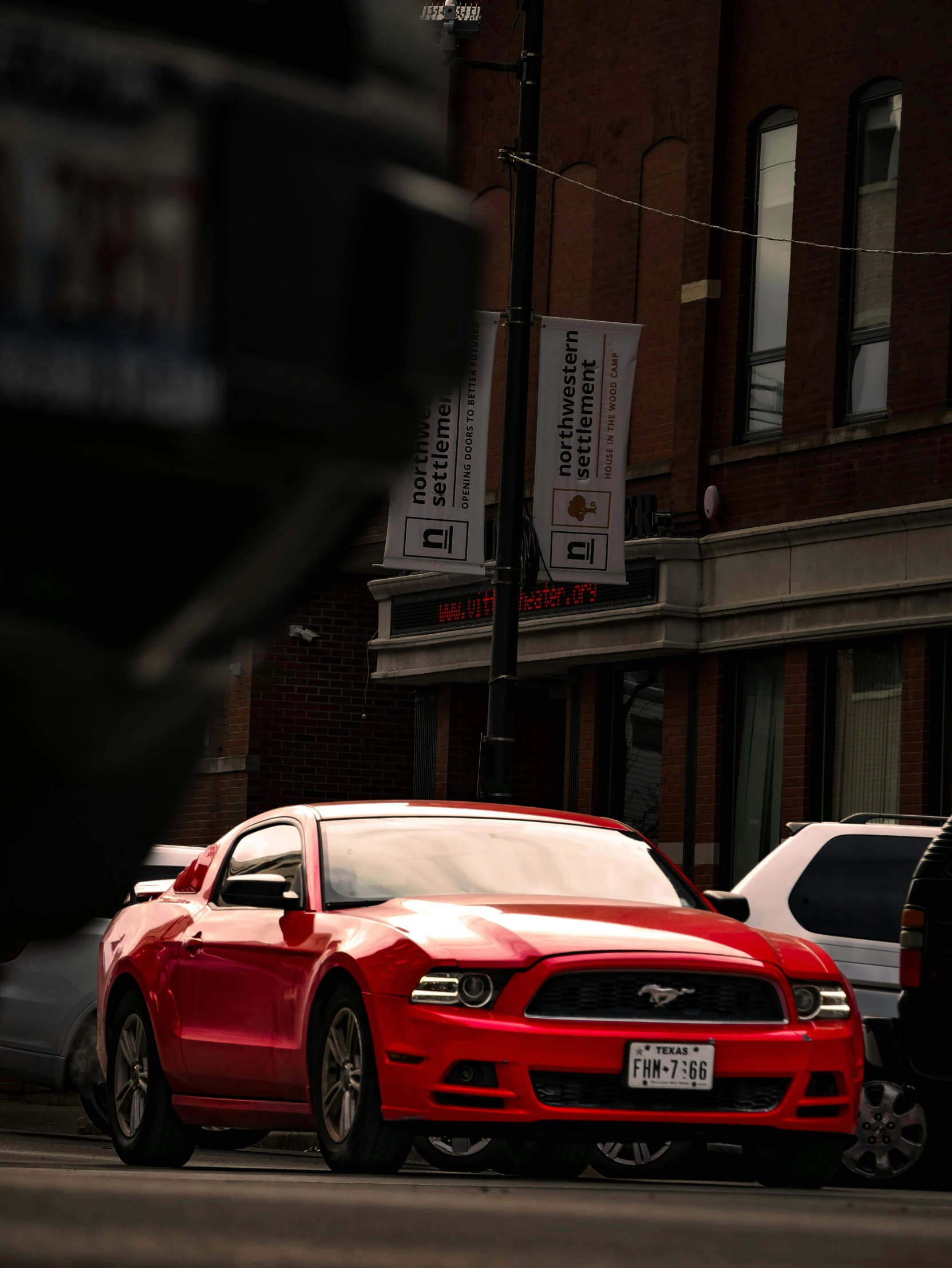 an american ford mustang parked on the side of the street