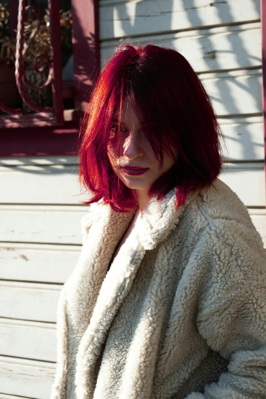 a girl in a white coat looks at the camera