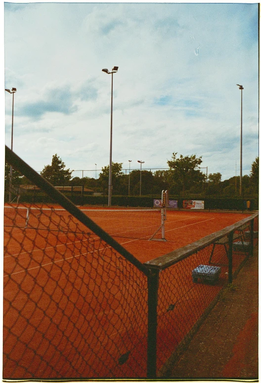 a pograph of a court from behind a fence