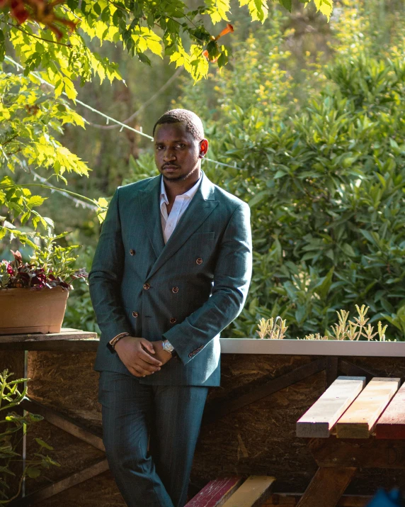 a man in a suit sits on a bench