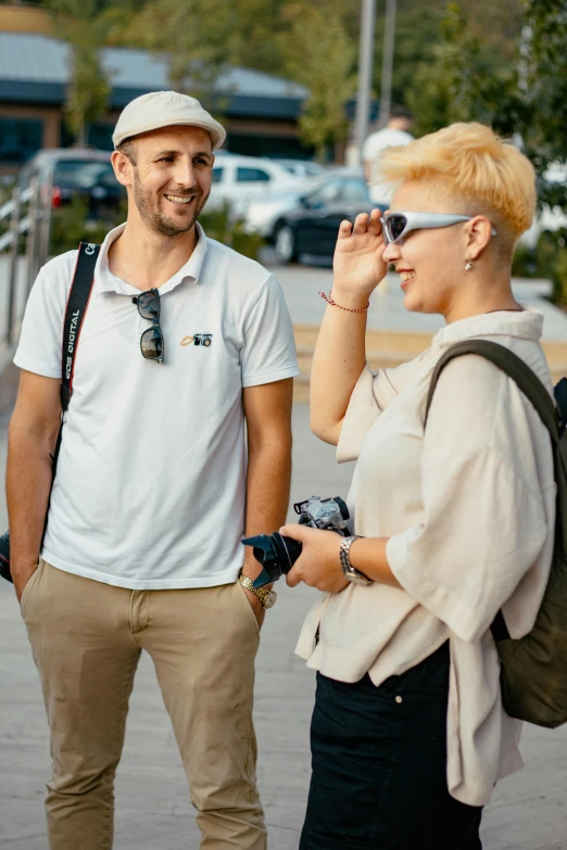 a man and woman standing in the middle of the road