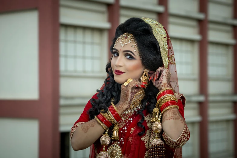 a woman dressed in indian clothes posing for a pograph