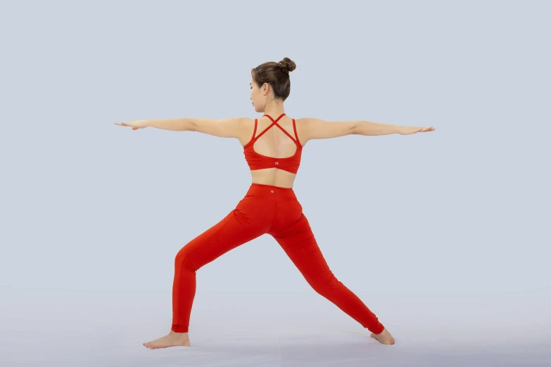 the woman is doing a yoga exercise with her arms outstretched