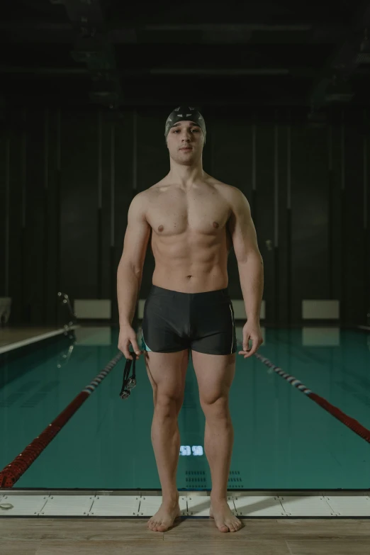 a young man is wearing his swimming shorts