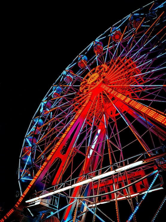 this colorful ferris wheel is lit up brightly