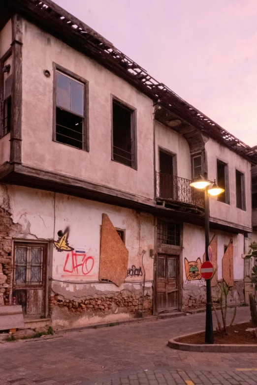 a run down building with graffiti on the walls