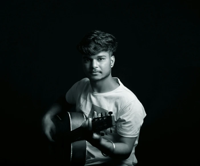 black and white pograph of a man with a guitar