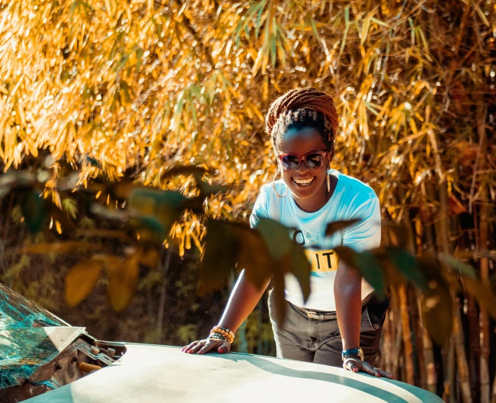 an african american woman smiles as she stands on her boat