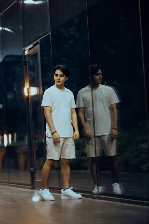 a couple of men standing in front of a glass door