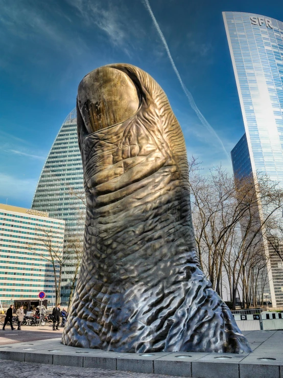 the giant elephant statue stands near the buildings