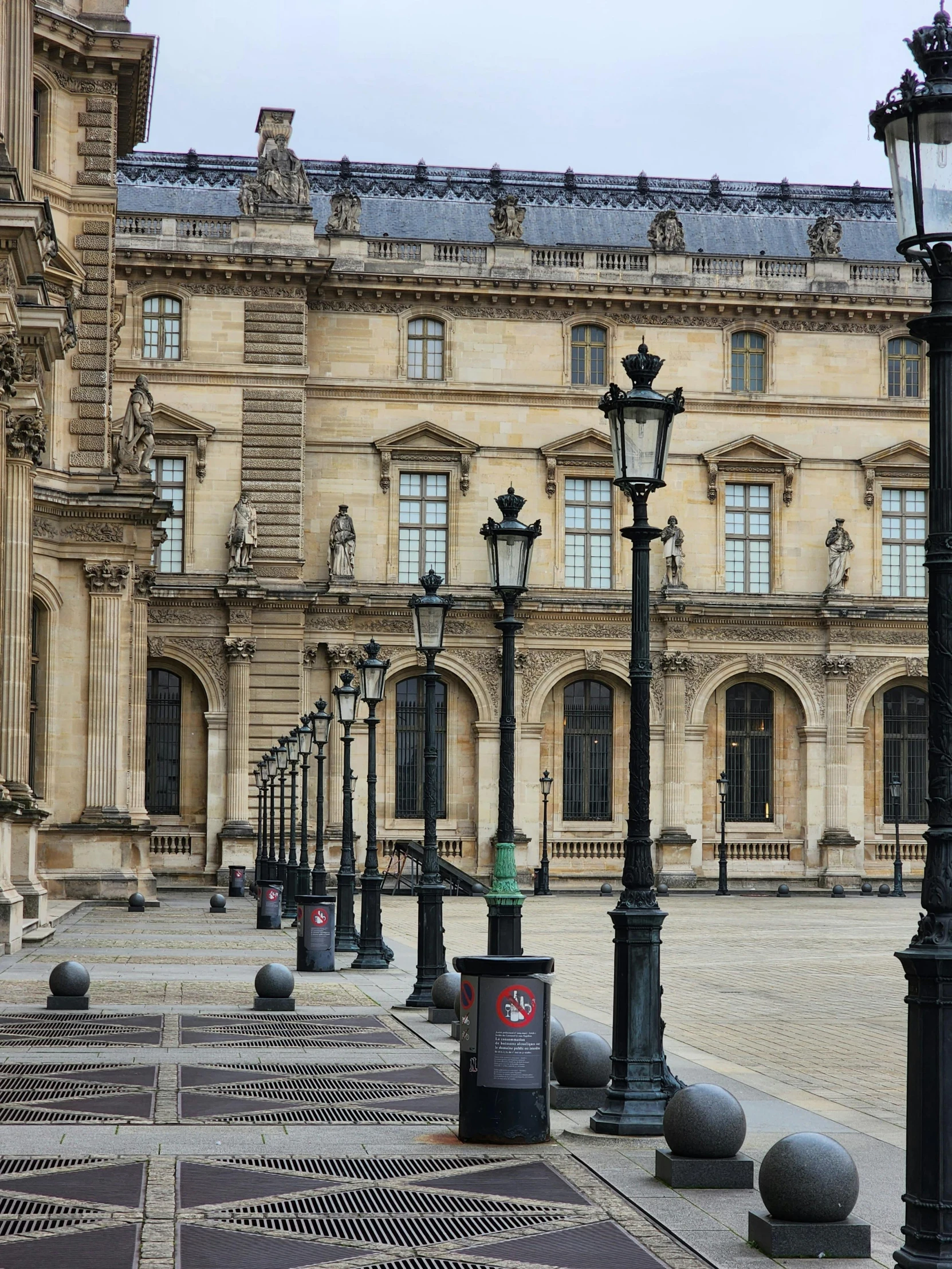 light poles are on the ground near some light posts