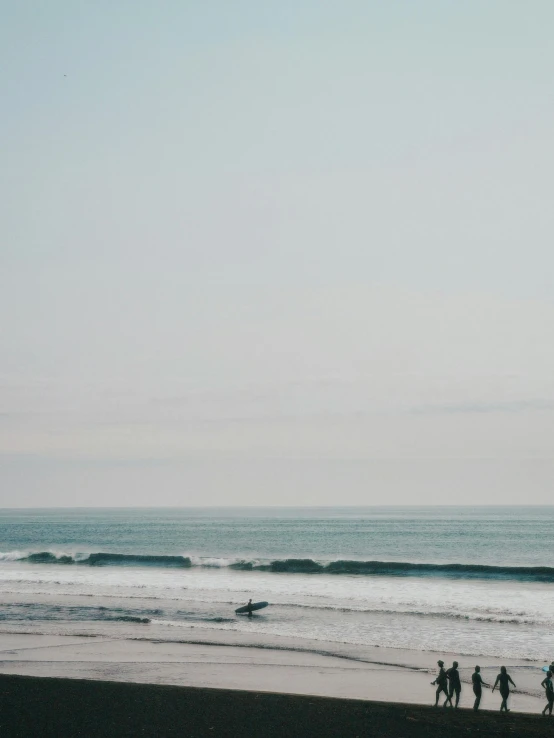 some people with surfboards at the beach