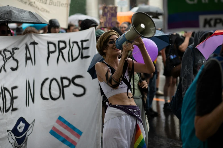 a woman with a megaphone on the street while protesting