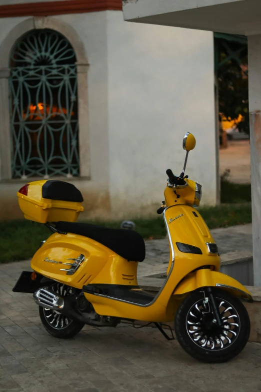 a motor scooter parked on a concrete patio