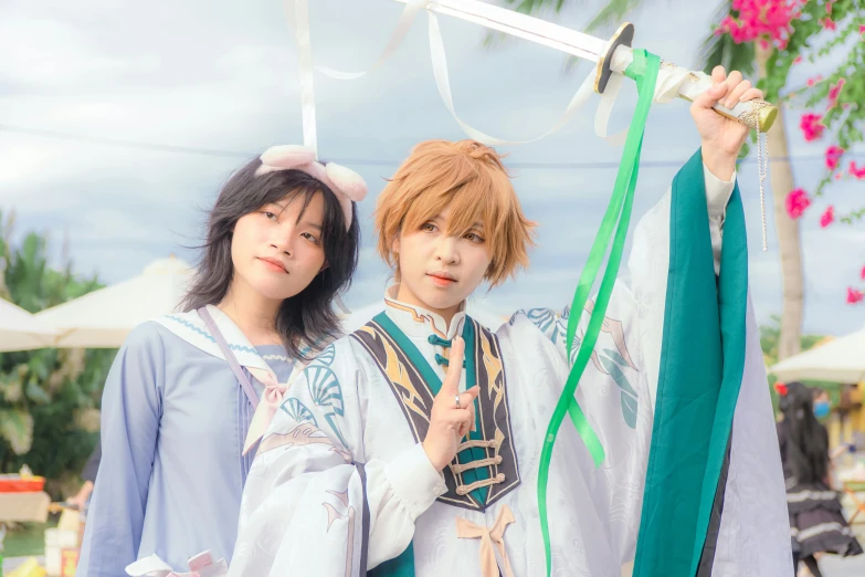 two asian woman wearing robes with a robe hanging from a clothes line